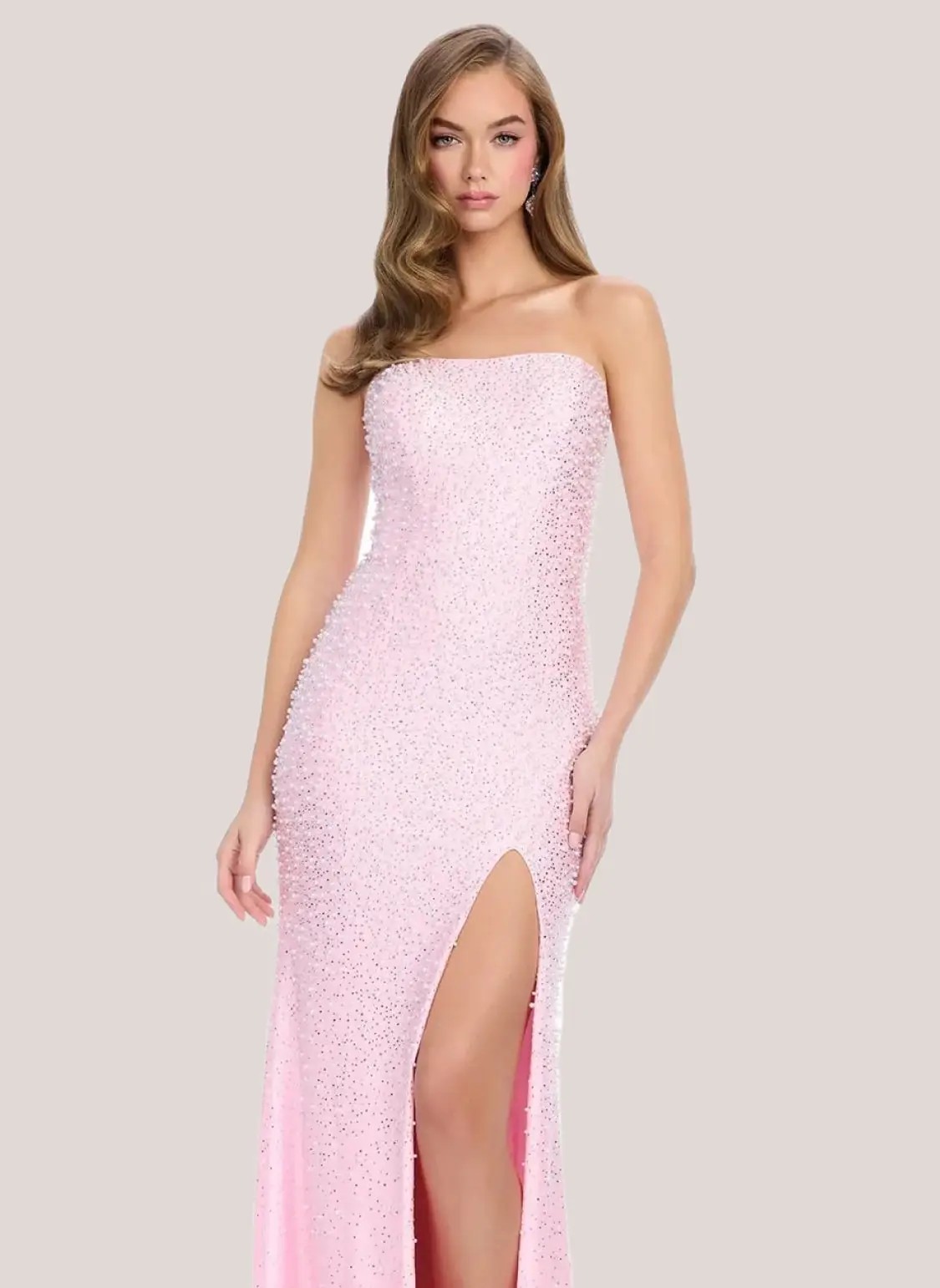 Model wearing a pink prom dress